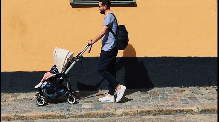 young father pushing stroller