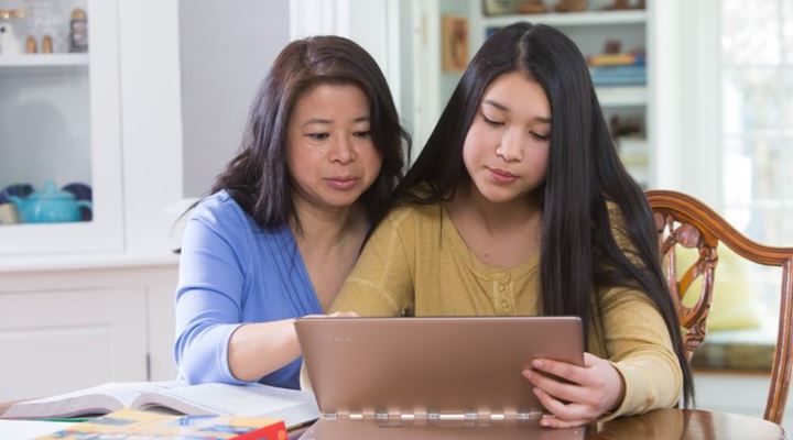 mother and daughter looking at computer