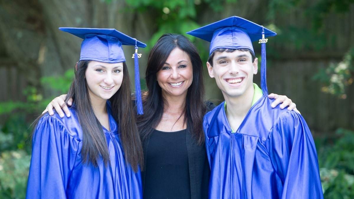 mom posing with two recent graduates