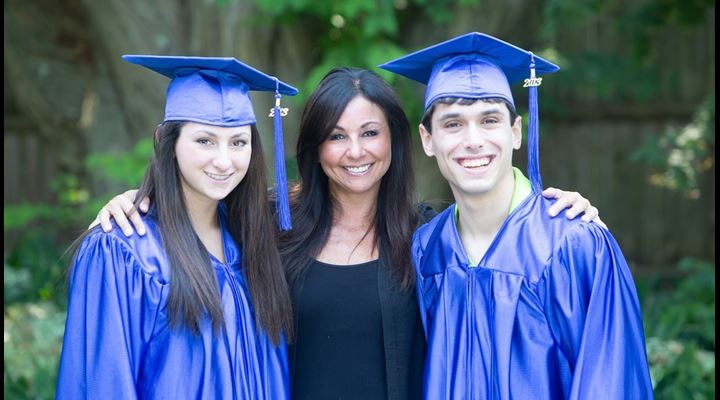 mom posing with two recent graduates