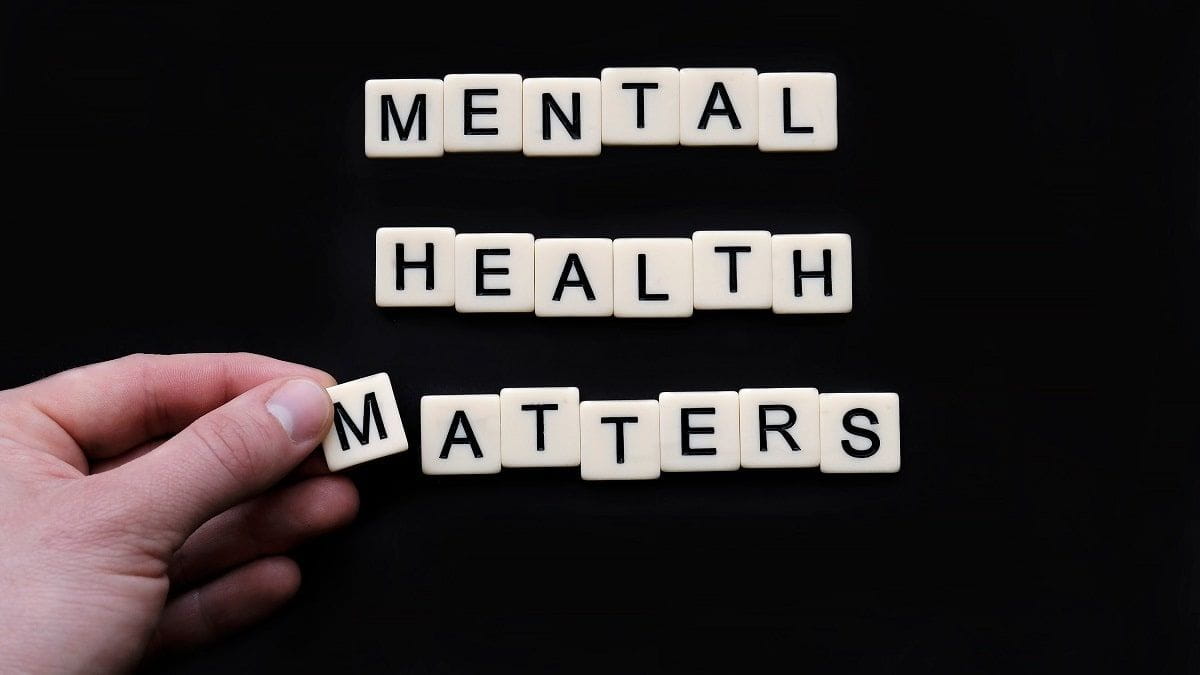 tiles on black surface reading mental health matters