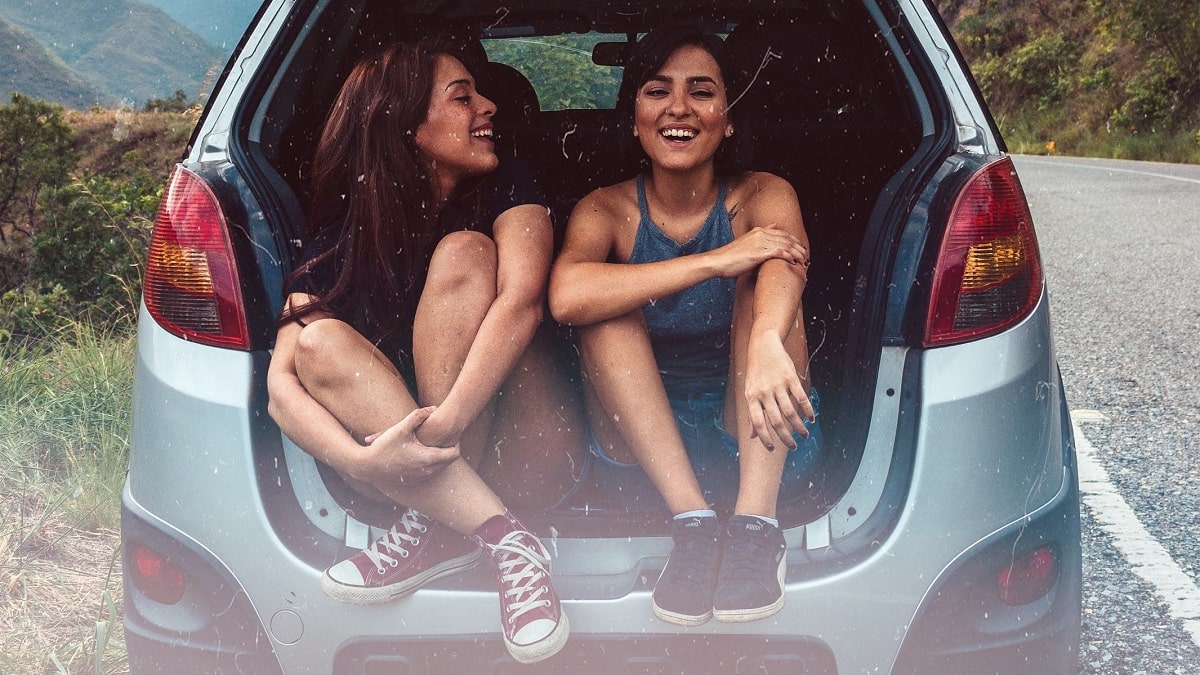 two women in back of car