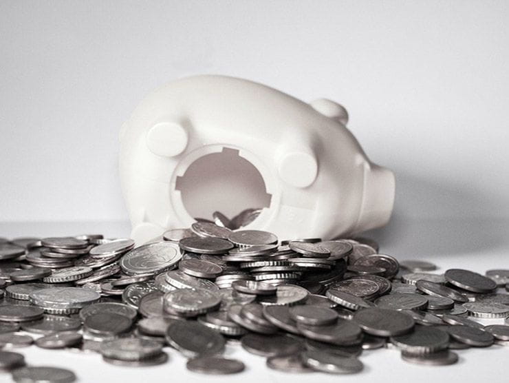 Piggy bank with coins spilling out