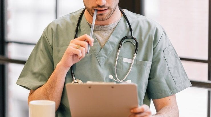 doctor-looking-at-clipboard