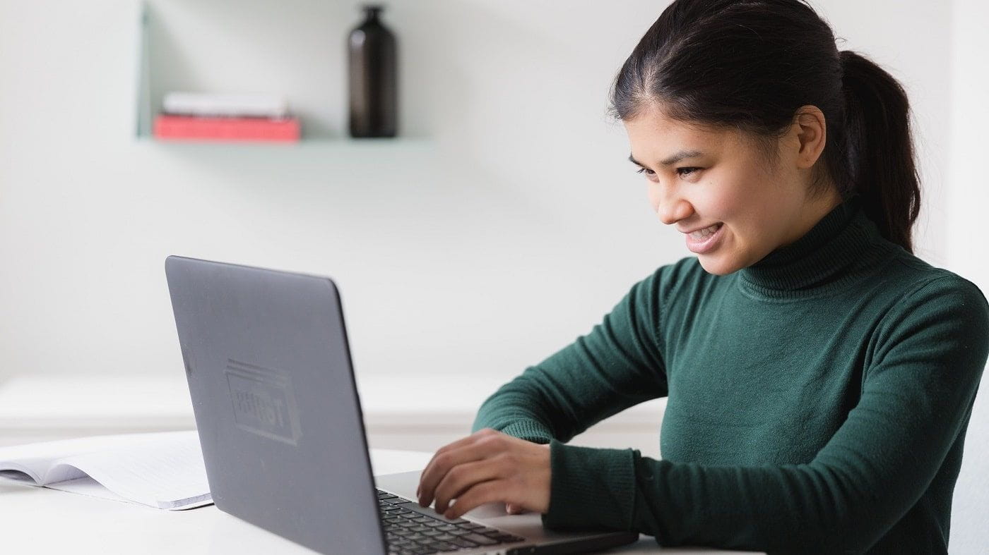 smiling woman working on laptop