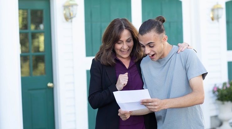 mother and son reading letter outside