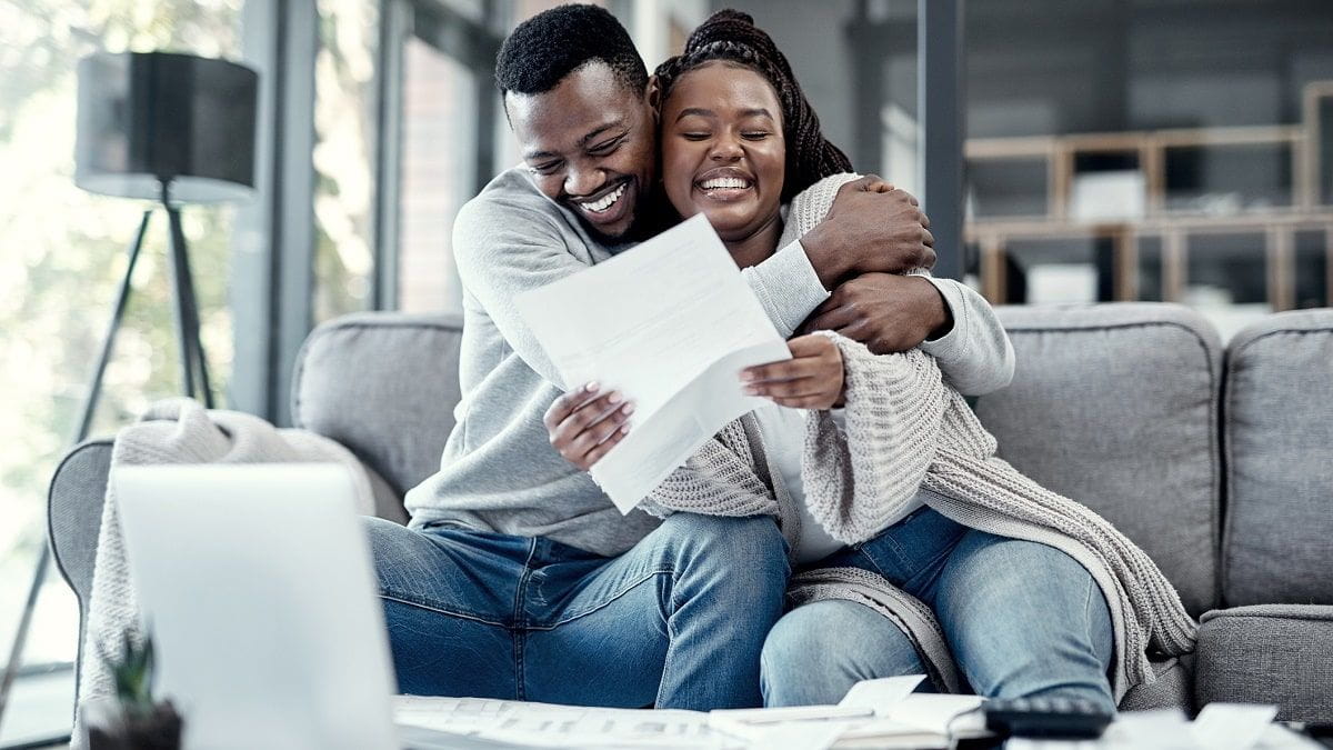 dad and daughter hugging while looking at paperwork