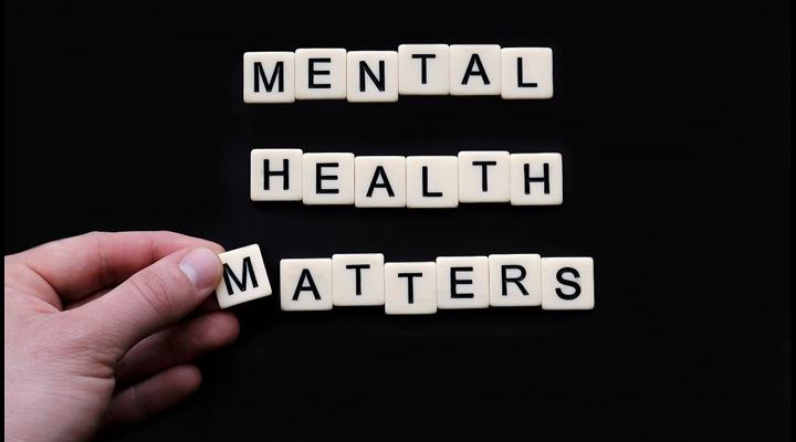 tiles on black surface reading mental health matters