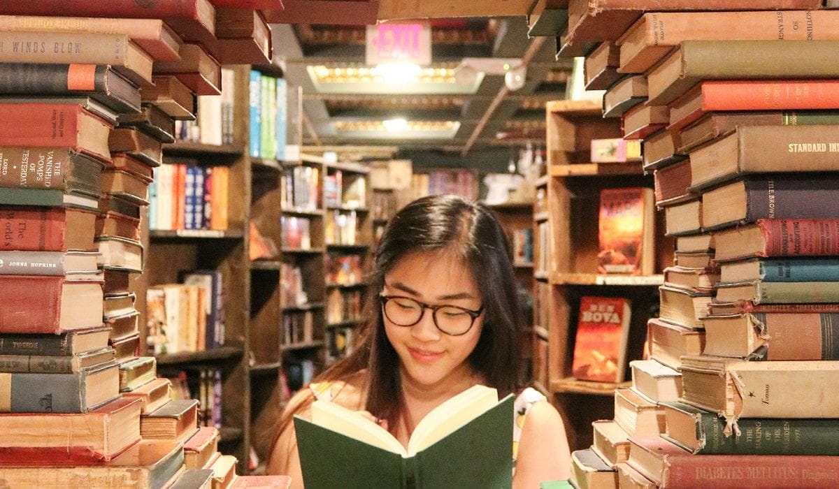 books arranged in a circle showing woman reading