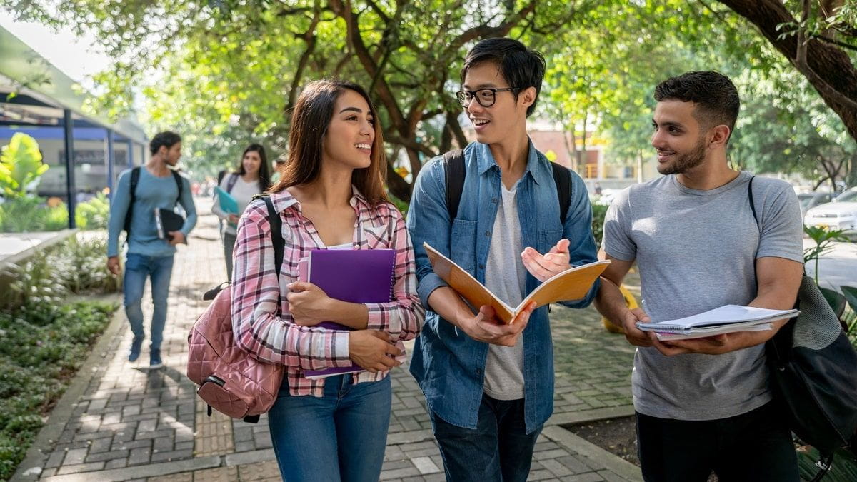 students walking and talking on college campus