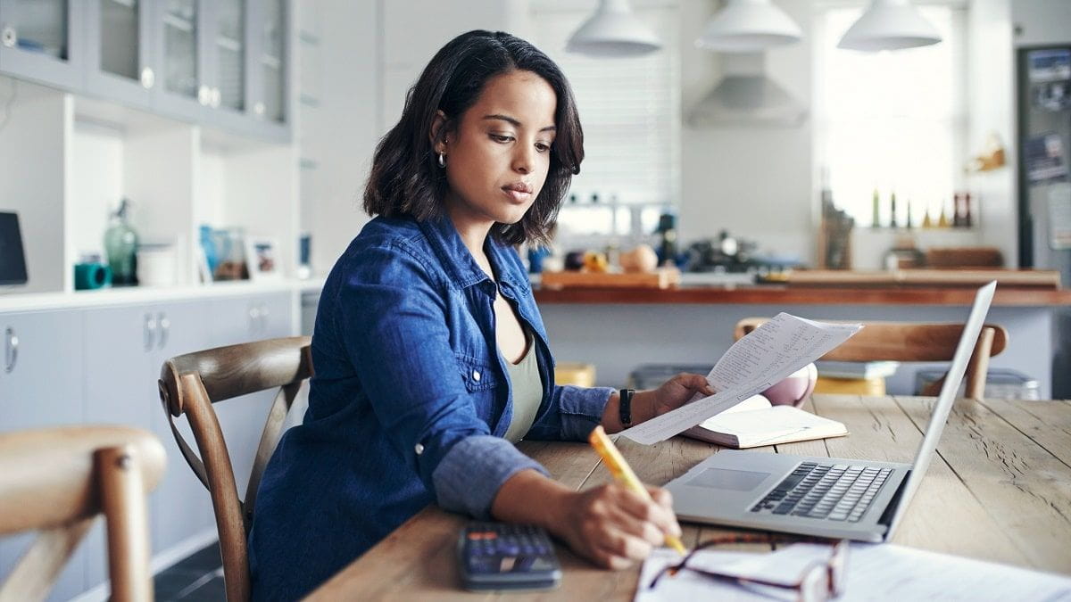 woman paying student loan bills on laptop