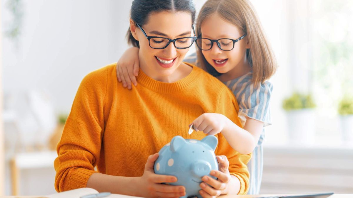 mom and young daughter with piggy bank