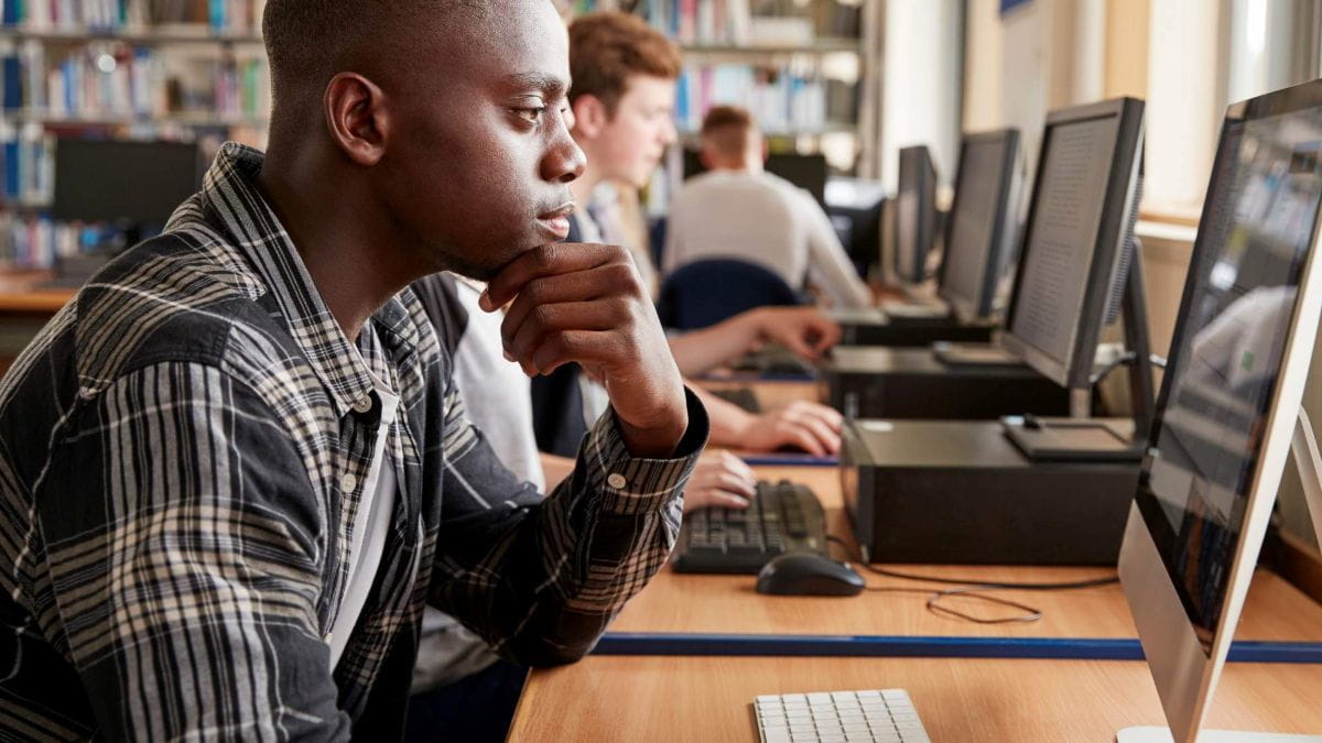 student working on computer at library