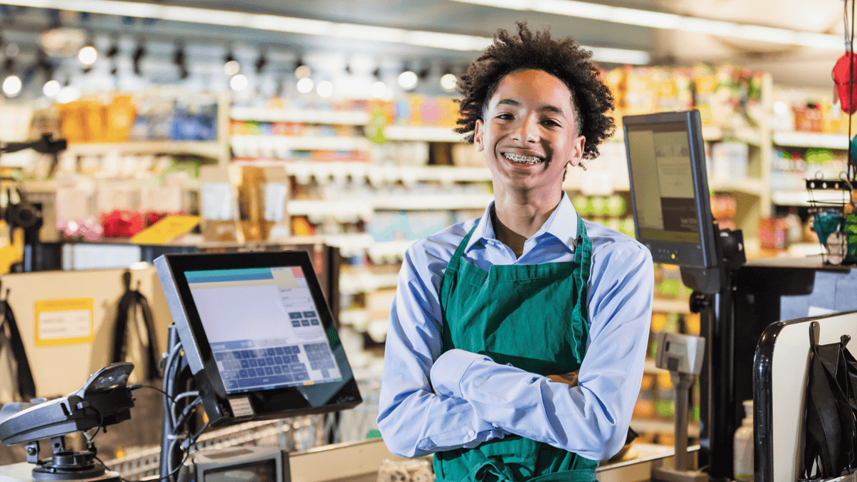teenager working as a cashier