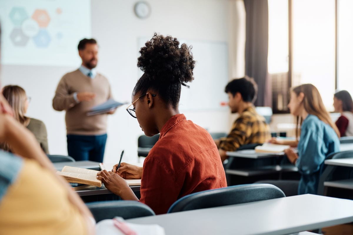 woman writing in classroom
